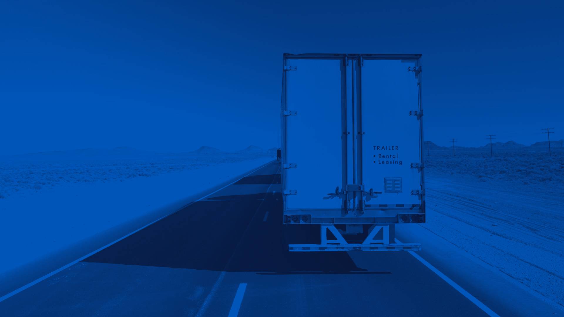 Rear of White Semi Trailer on a Desert Highway