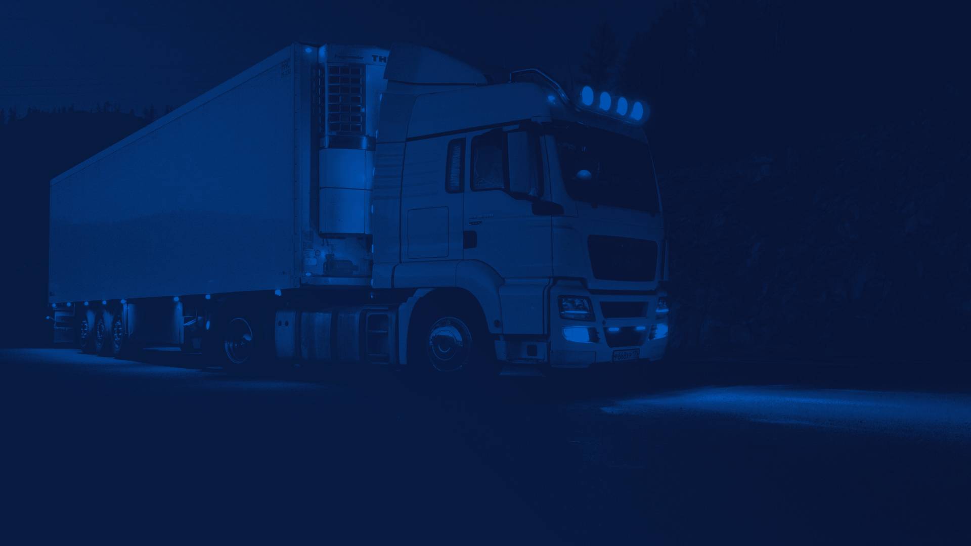 White Semi Truck Driving at Night