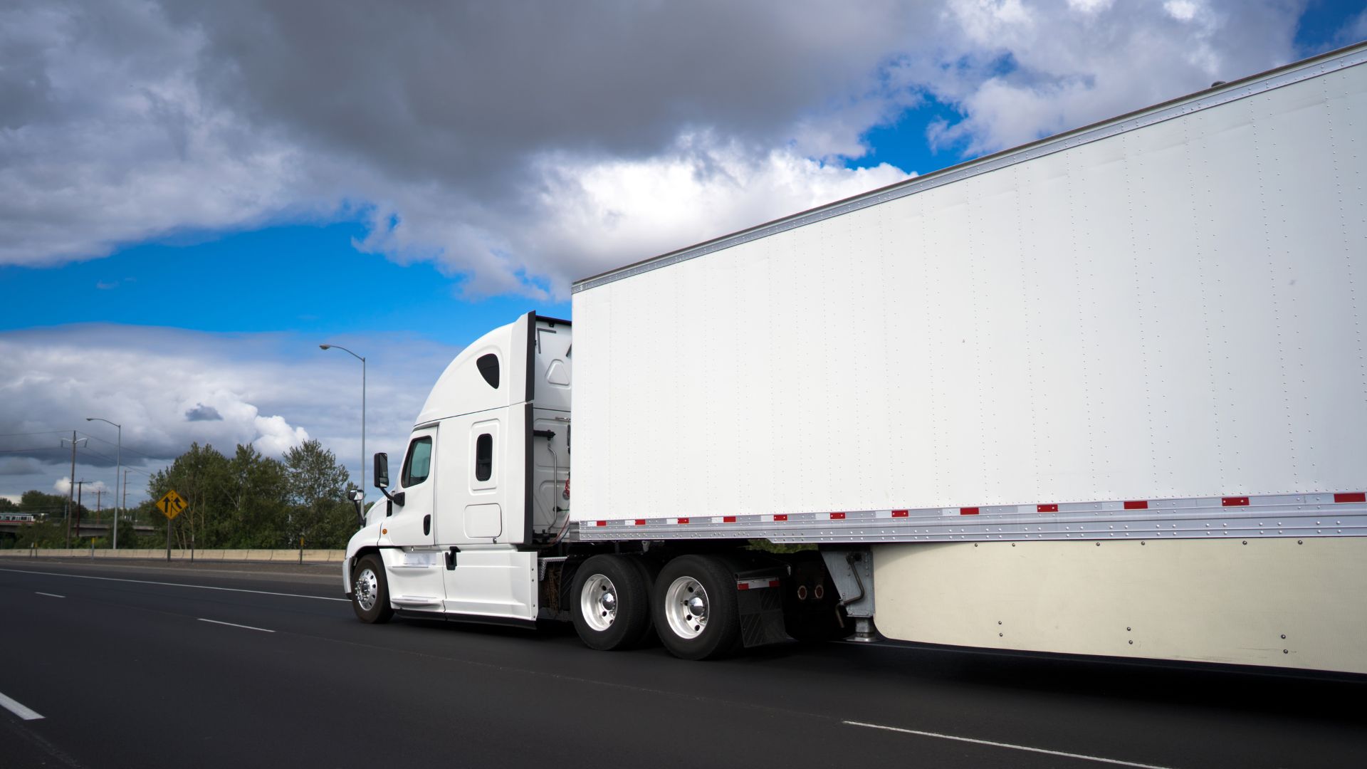 White Semi Truck Driving on Highway