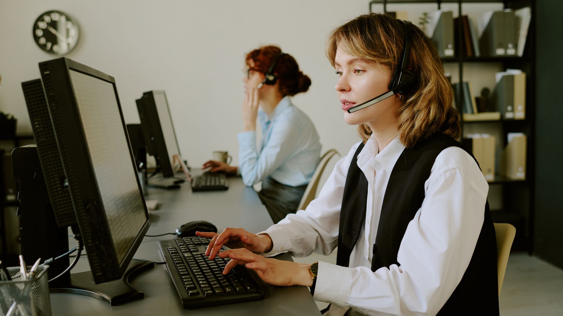 Customer Support Representative by Computer on a Phone