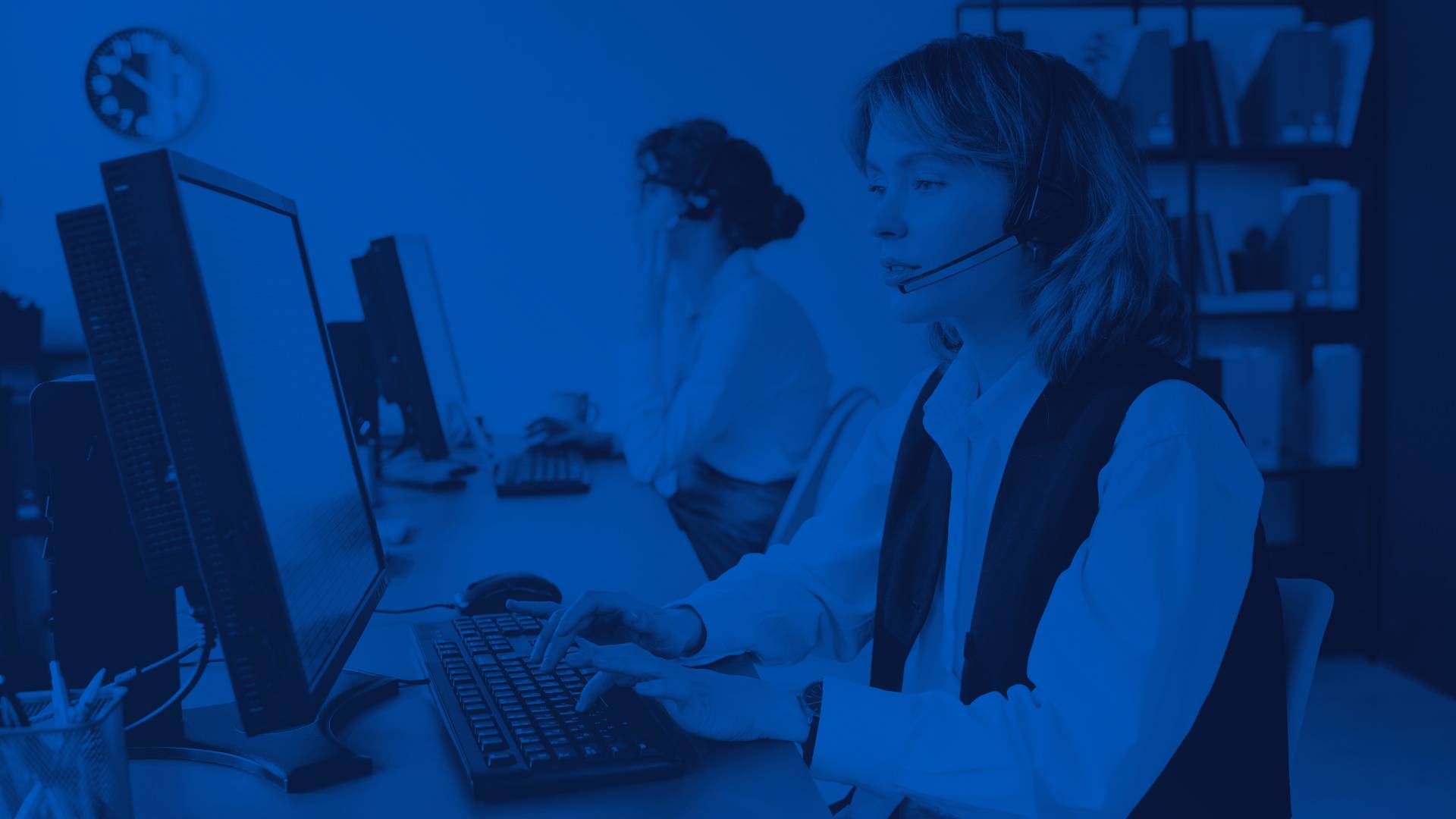 Customer Support Representative by Computer on a Phone