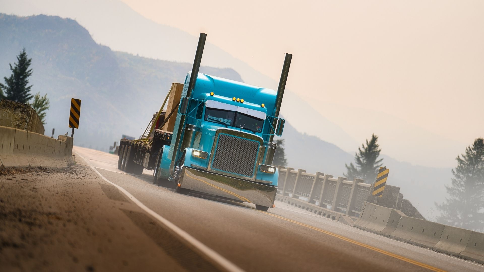 Teal Semi Truck Driving on a Bridge