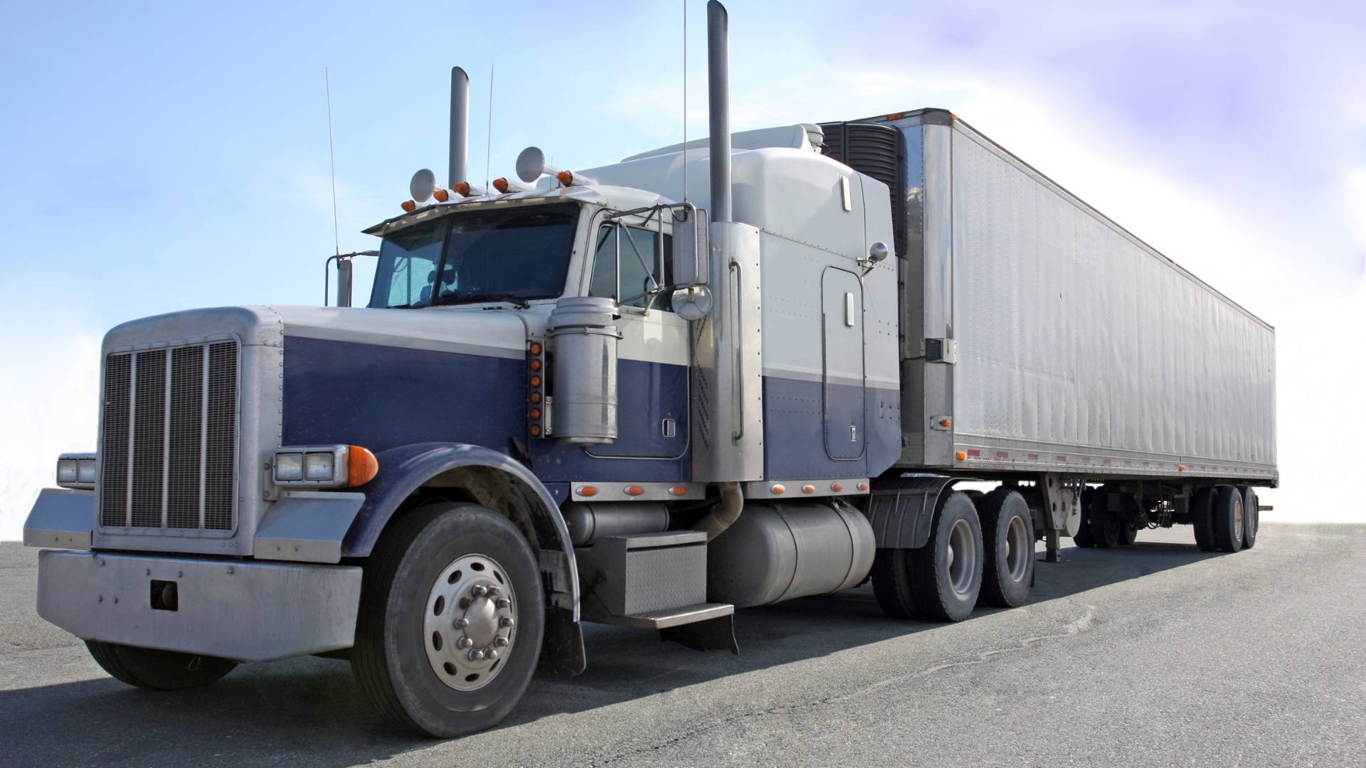 Gray and White Semi Truck on a Road
