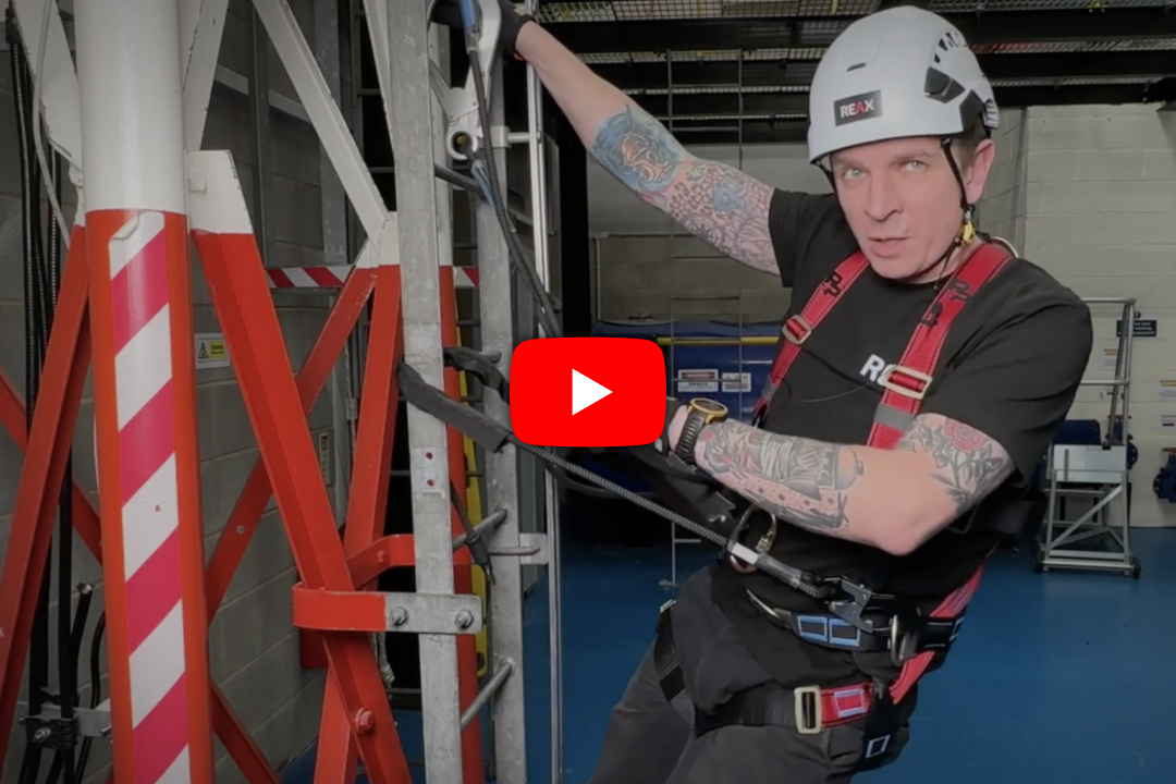 REAX instructor holding onto a structure with lanyards