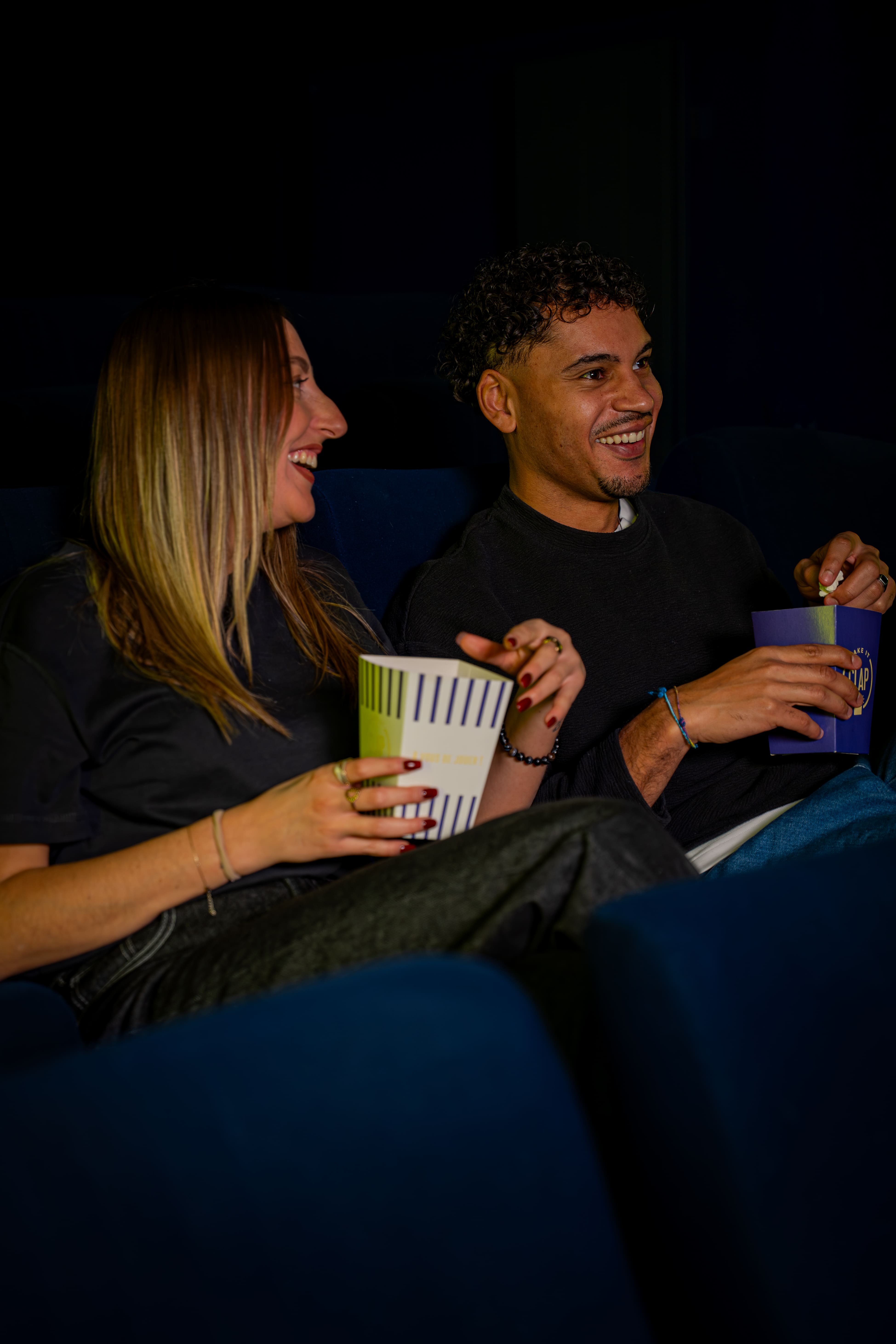 Two friends whatching their own movie