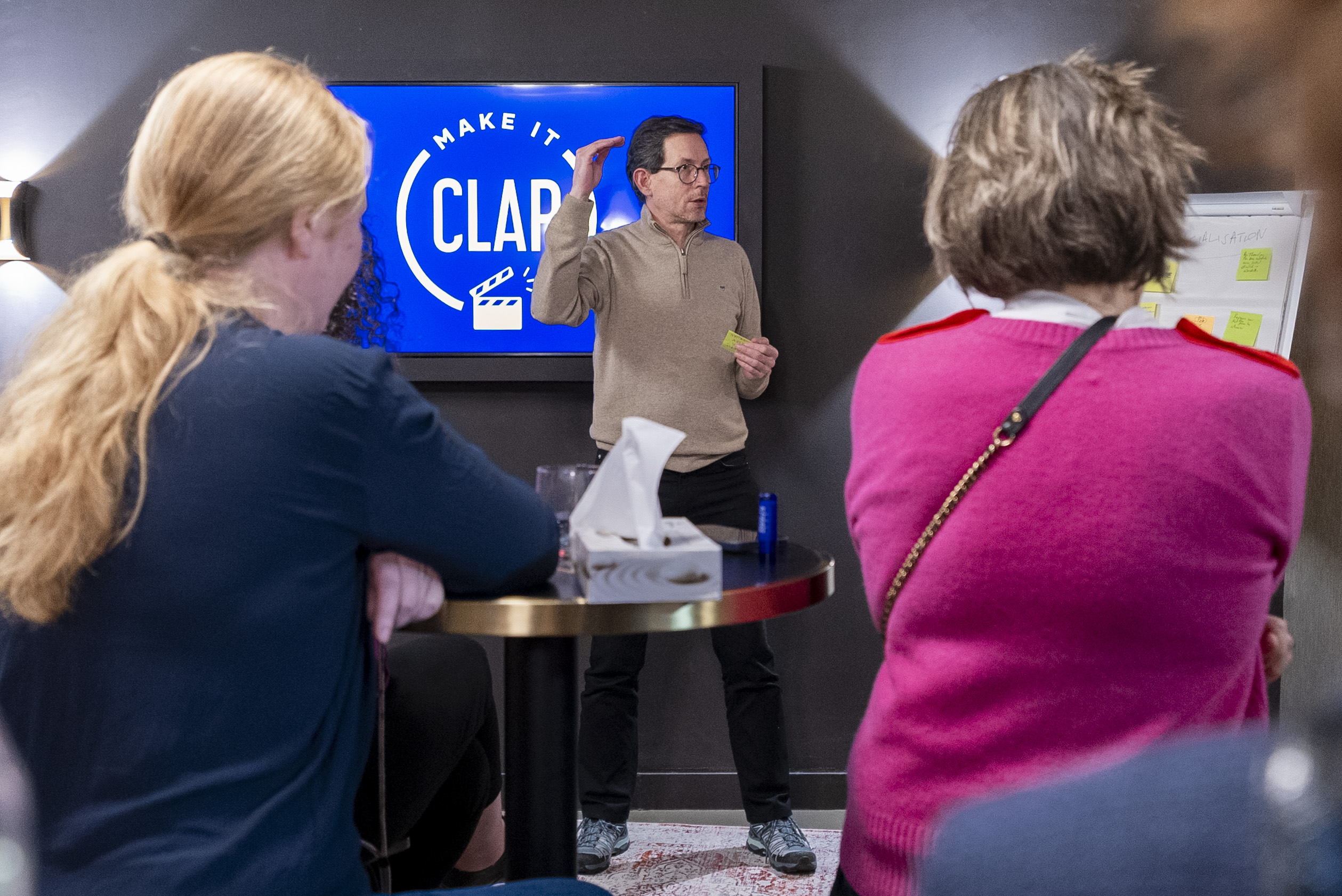 A group of coworkers listening to a presentator
