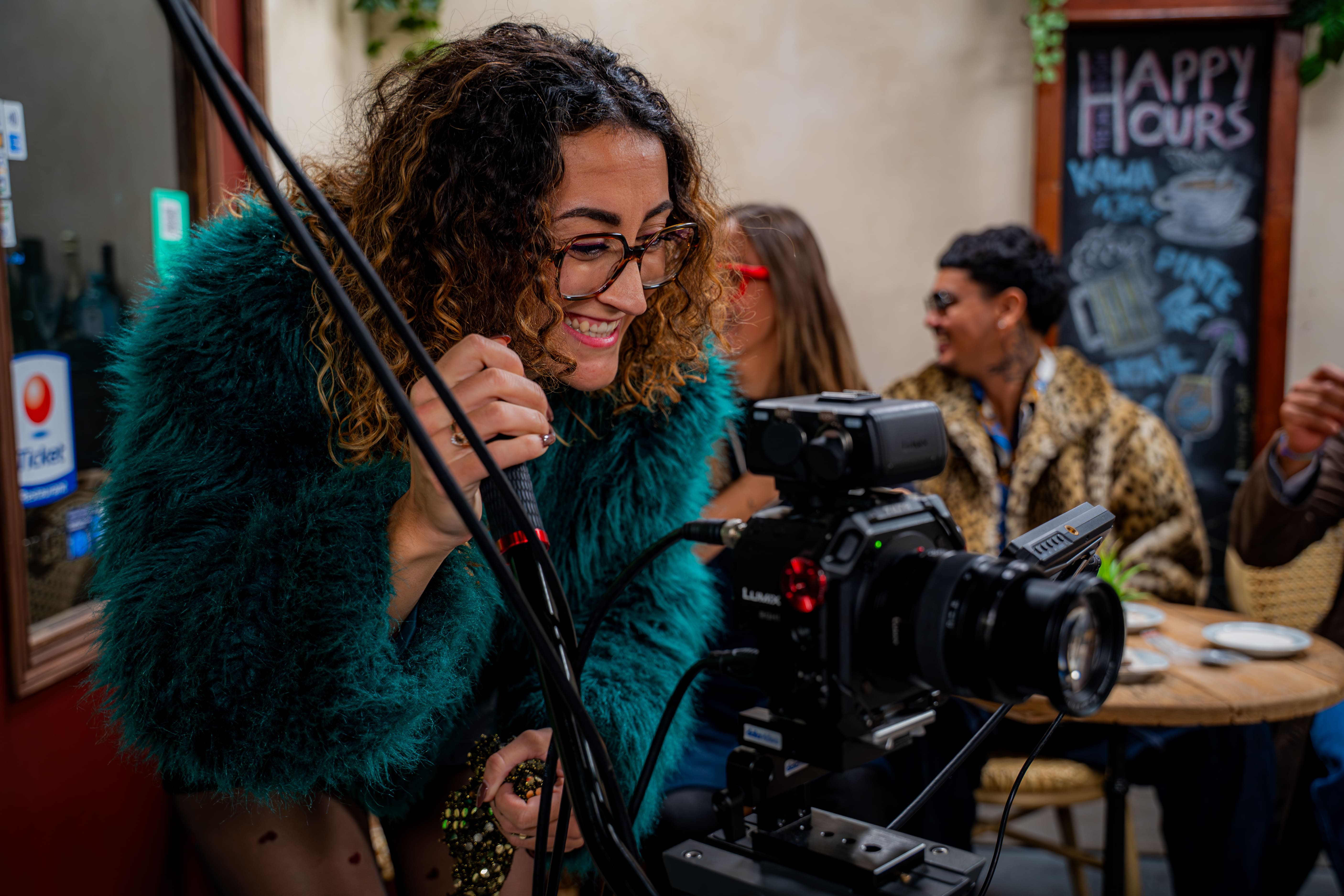 A girl is holding a camera and filming her friends