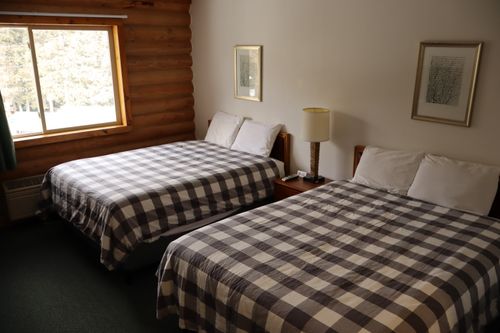 A double queen bedroom with floral bed spreads