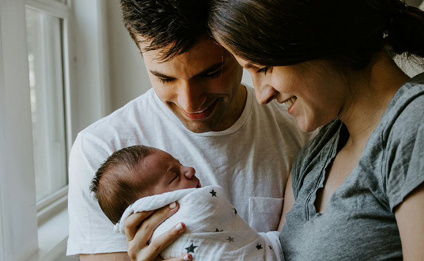 Parents holding newborn baby