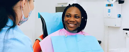 Young woman in dental chair smiling