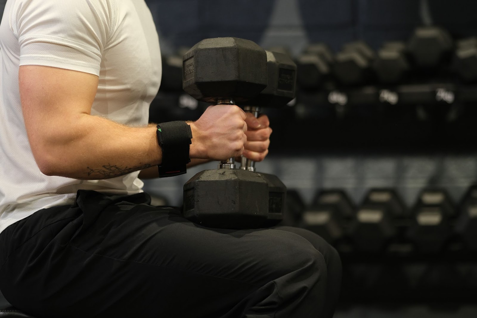 Barbell Velocity Tracker attached to the wrist for a dumbell based exercise