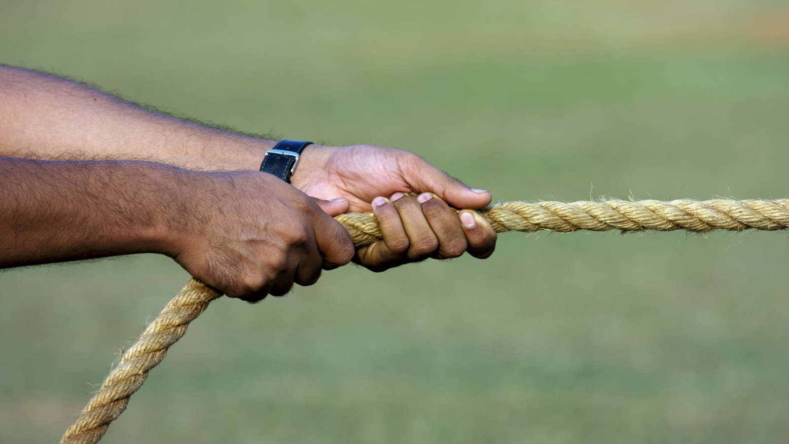 hands gripping a moving rope, used to illustrate how muscle produces force.