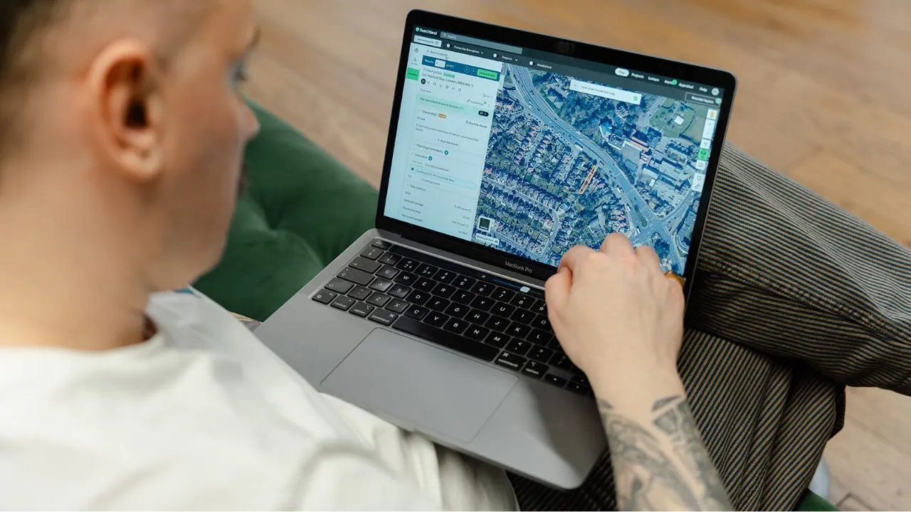 Man trying out Searchland on a laptop