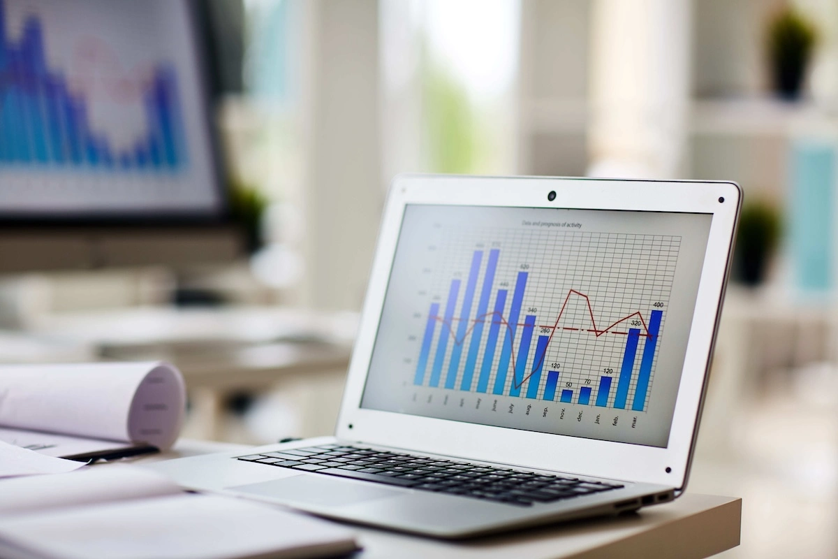 Laptop displaying data charts and trend analysis, illustrating Searchland's Technology as a Delivery Tool planning report