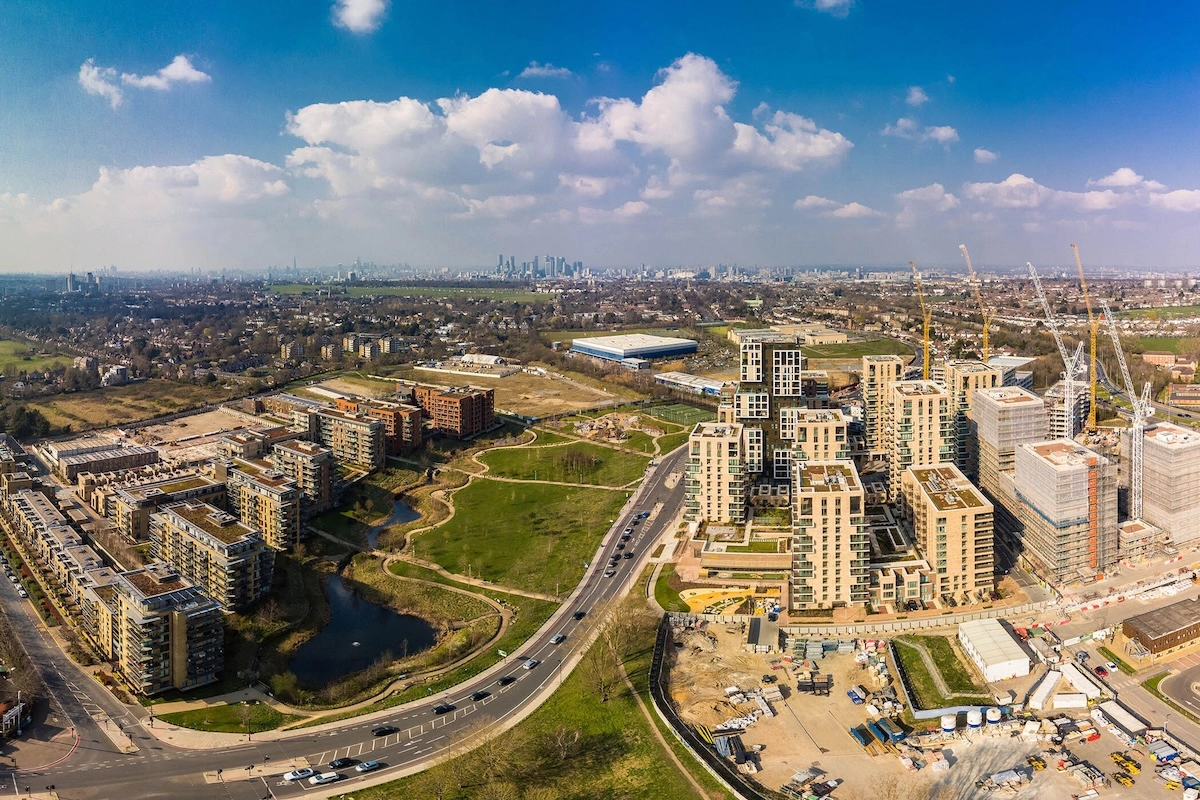 Aerial view of a large UK residential development under construction alongside established housing, illustrating delivery under the NPPF