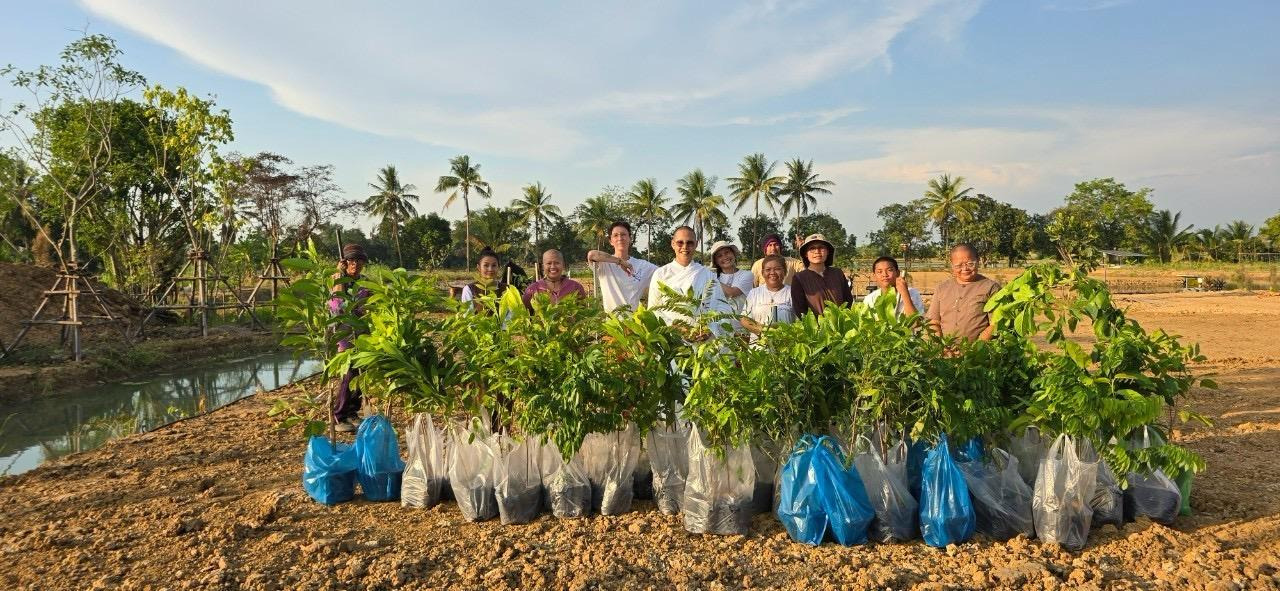 A group of people standing in a field with plantsAI-generated content may be incorrect.