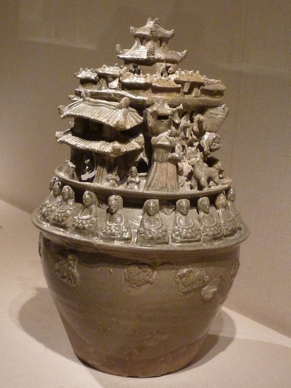 A large ceramic pot with a group of peopleAI-generated content may be incorrect.