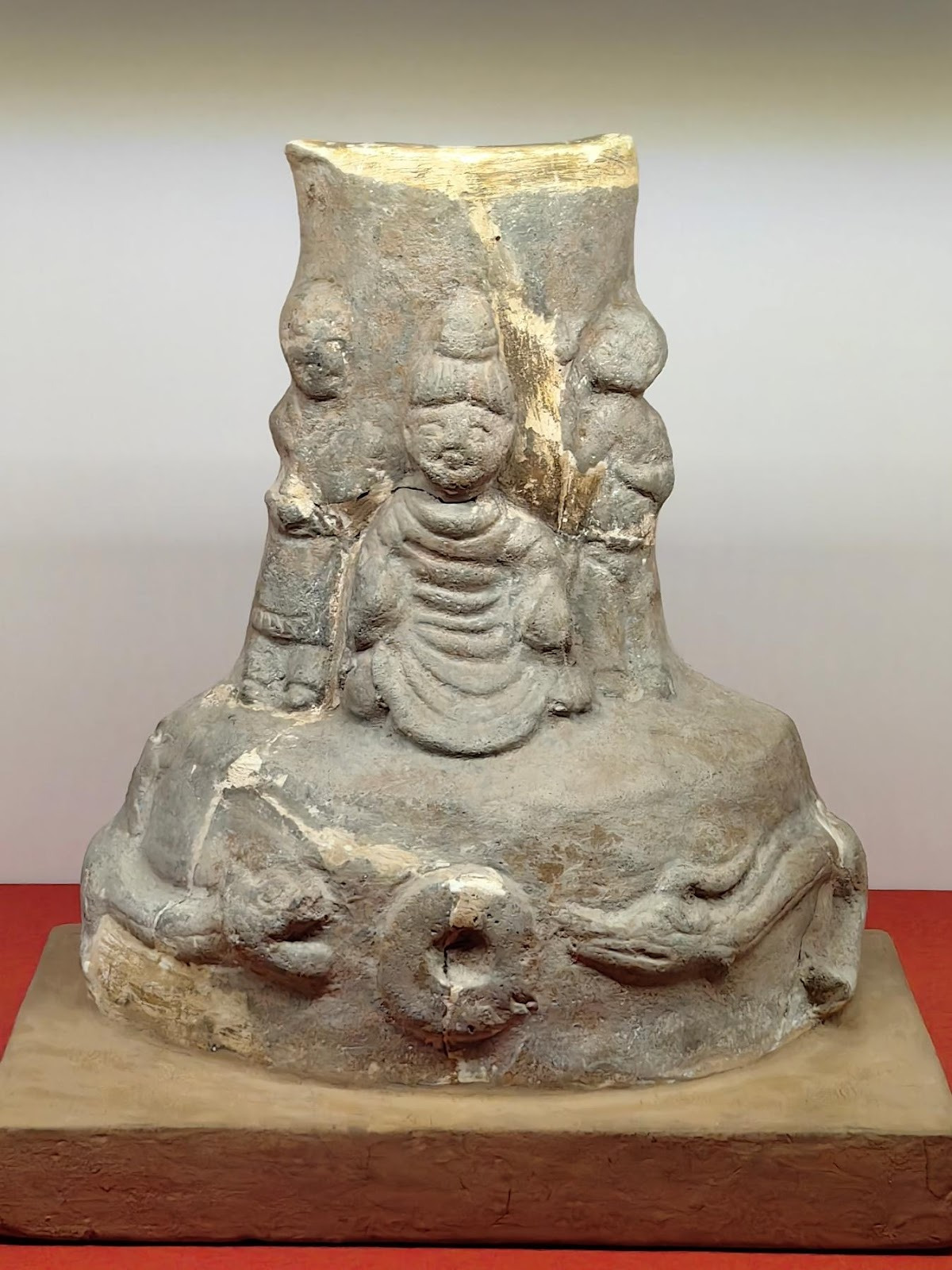 A stone statue with a group of peopleAI-generated content may be incorrect.