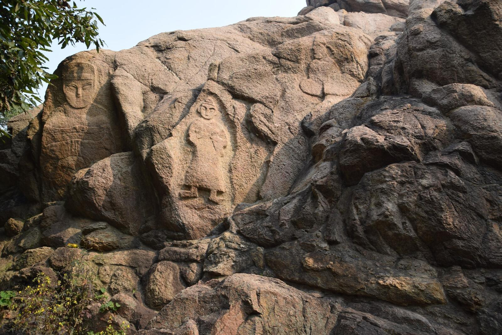 A large rock with a carved figureAI-generated content may be incorrect.