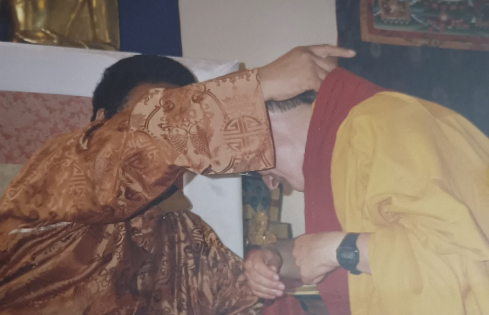 A person in a robe pointing at another person's headAI-generated content may be incorrect.