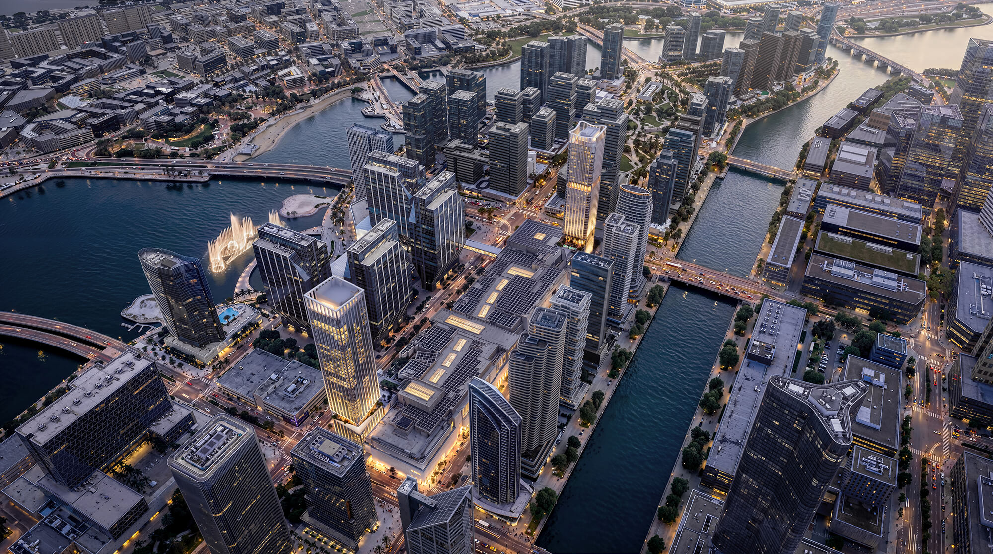 Aerial view of Chicago downtown skyline with illuminated skyscrapers and surrounding waterways at dusk.