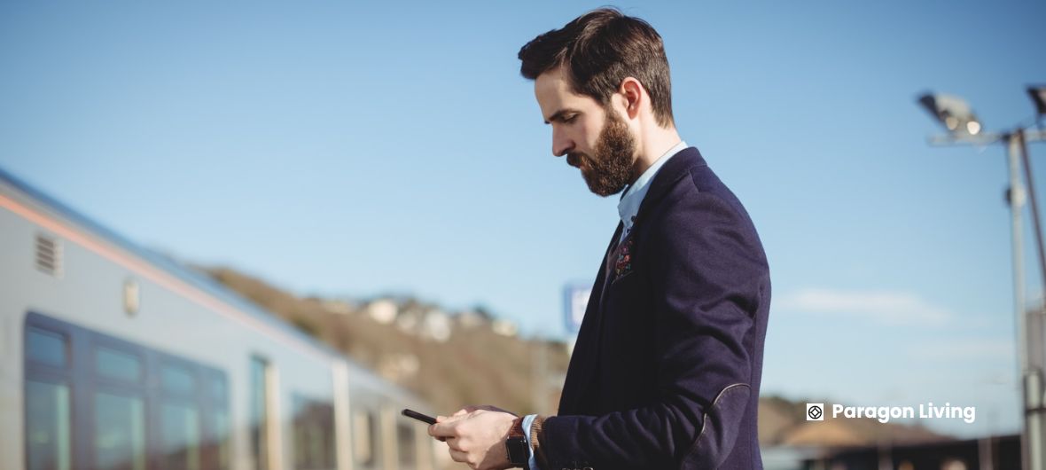 A suited man stands next to a train, representing a central hub for connectivity.
