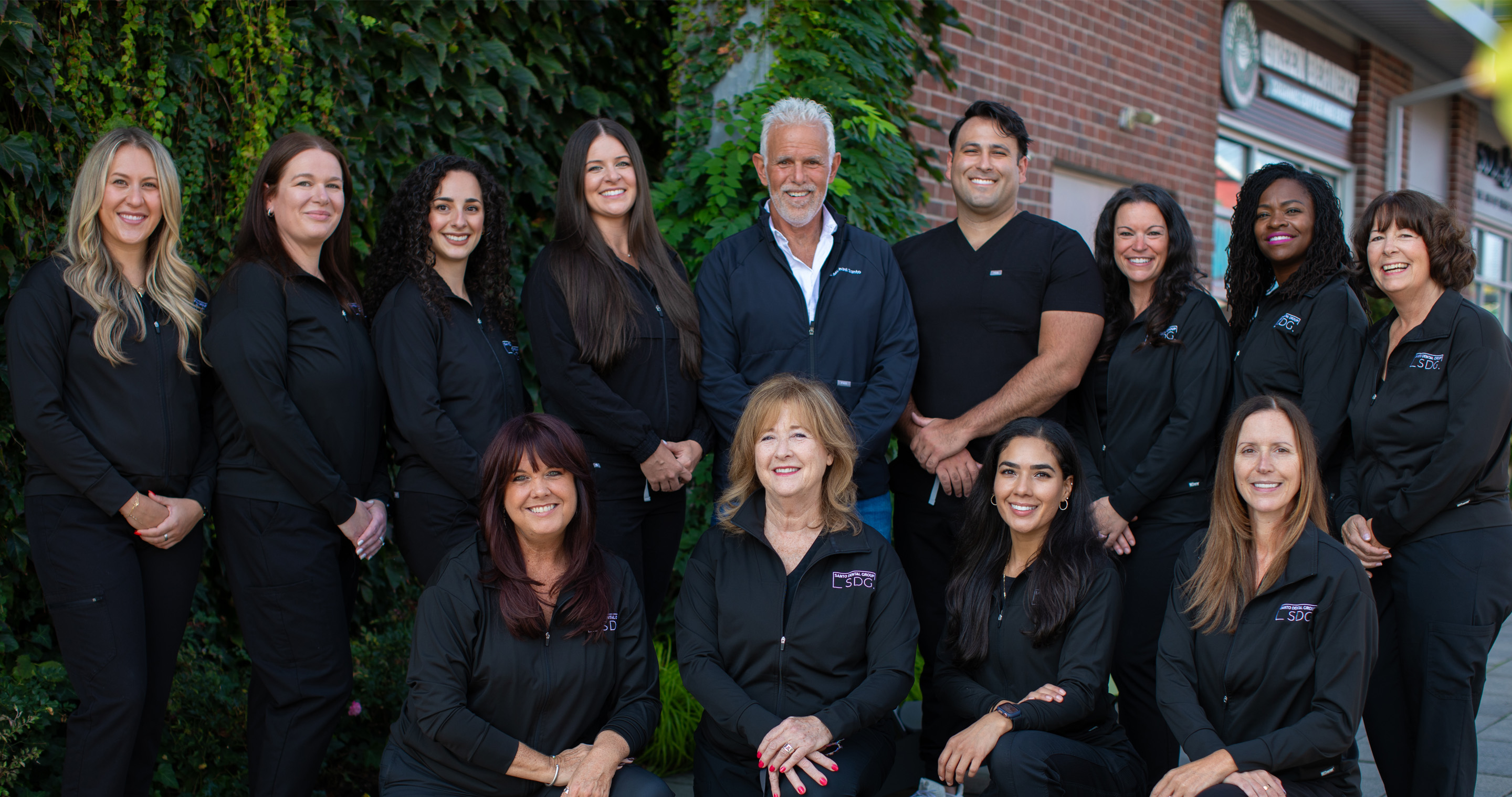 The Santo Dental Team Standing in front of the practice