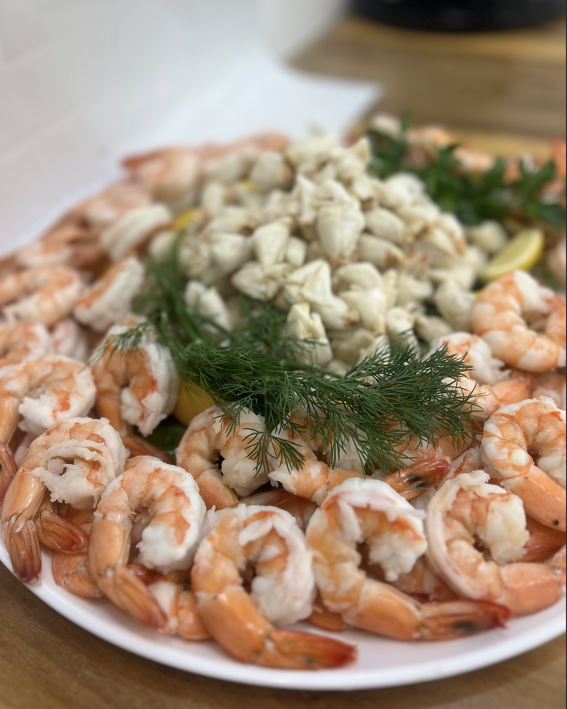 A platter with shrimp cocktail and jumbo lump crab