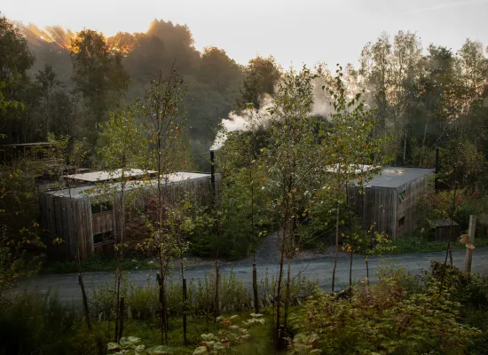 A Cosy Cabin with smoke coming out from the woodstove chimney