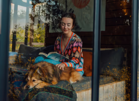 A woman on a solo trip with her dog in a Nutchel cosy cabin