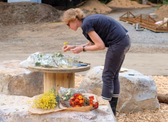 A Nutchel team member arranging flowers for the reception before the opening of Nutchel Les Ardennes