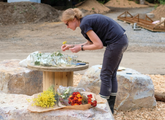 A Nutchel team member arranging flowers for the reception before the opening of Nutchel Les Ardennes
