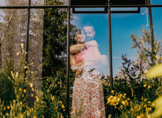 A couple looking through the window during a romantic stay in a cabin in the woods