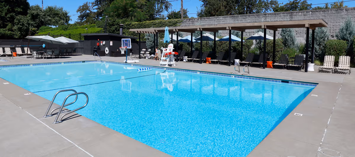 Family-friendly swimming pool surrounded by shaded lounge chairs