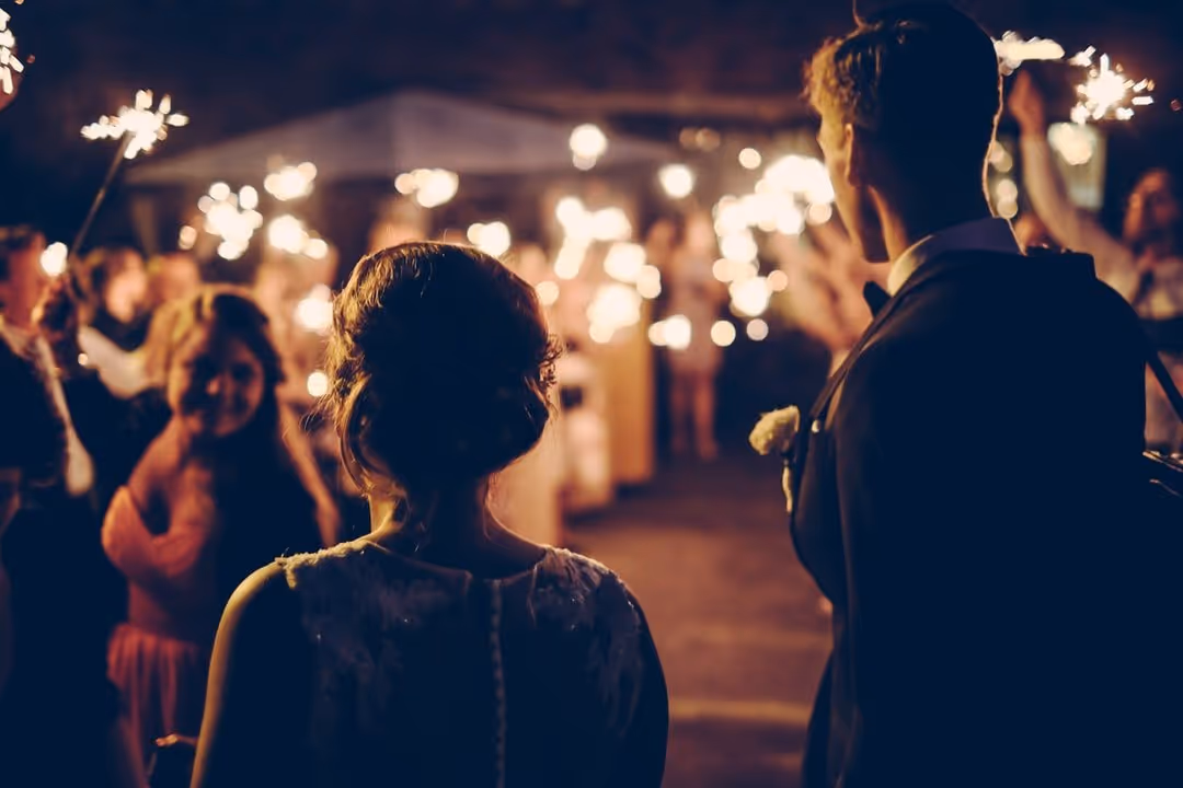 A bride and groom greet their guests at their wedding reception