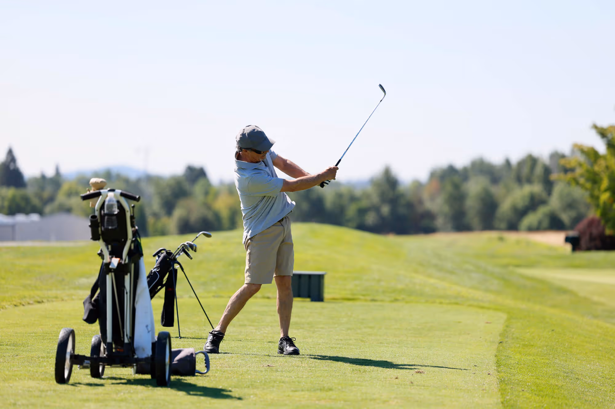 Male golfer takes a practice drive on the Mason Course
