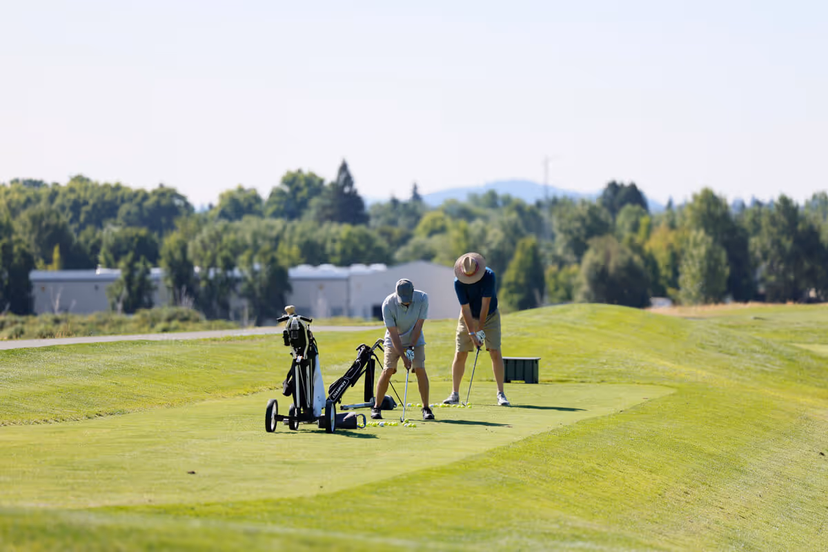Two male golfers line up their shots on the Mason Course
