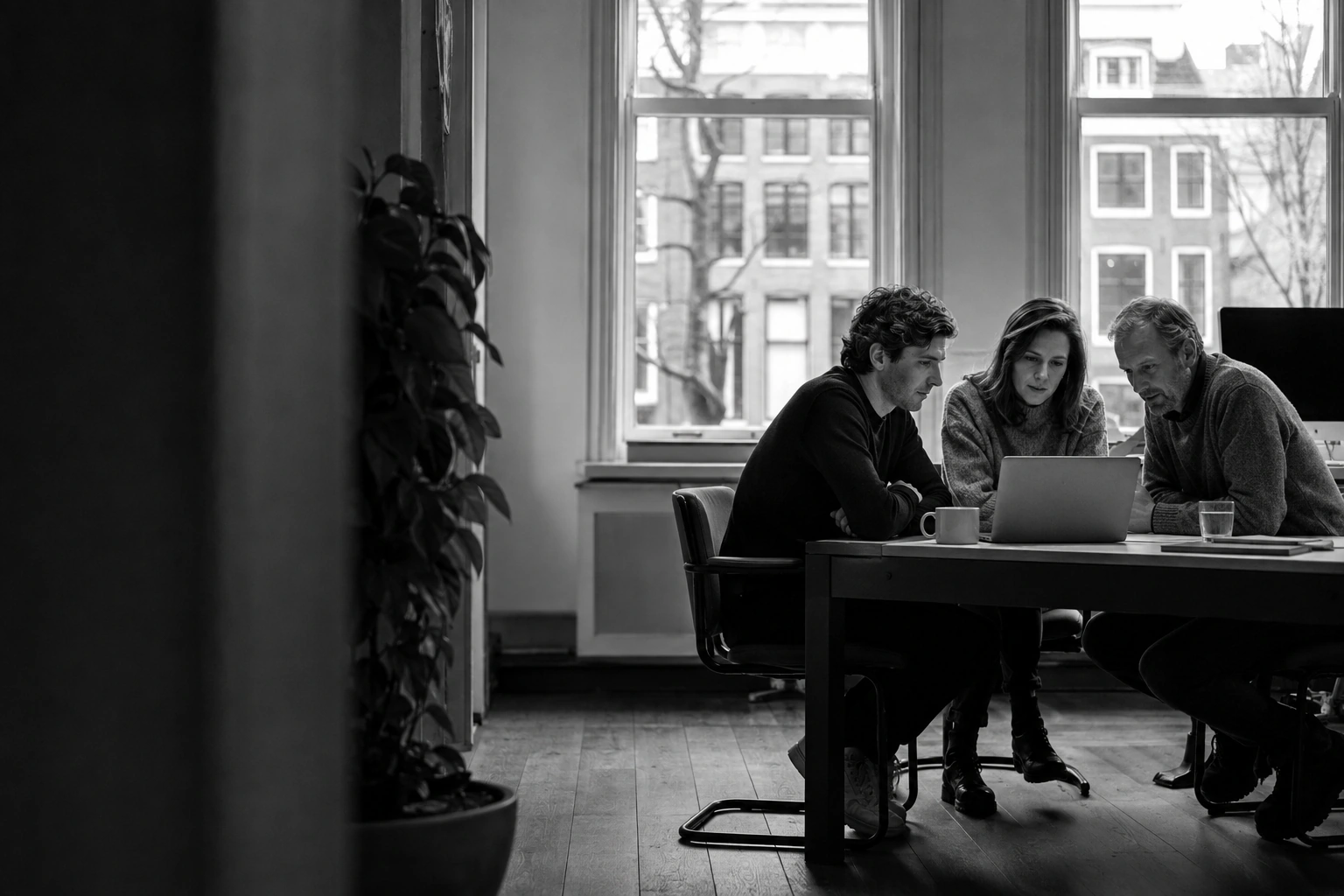 An illustrative group focused on a shared laptop