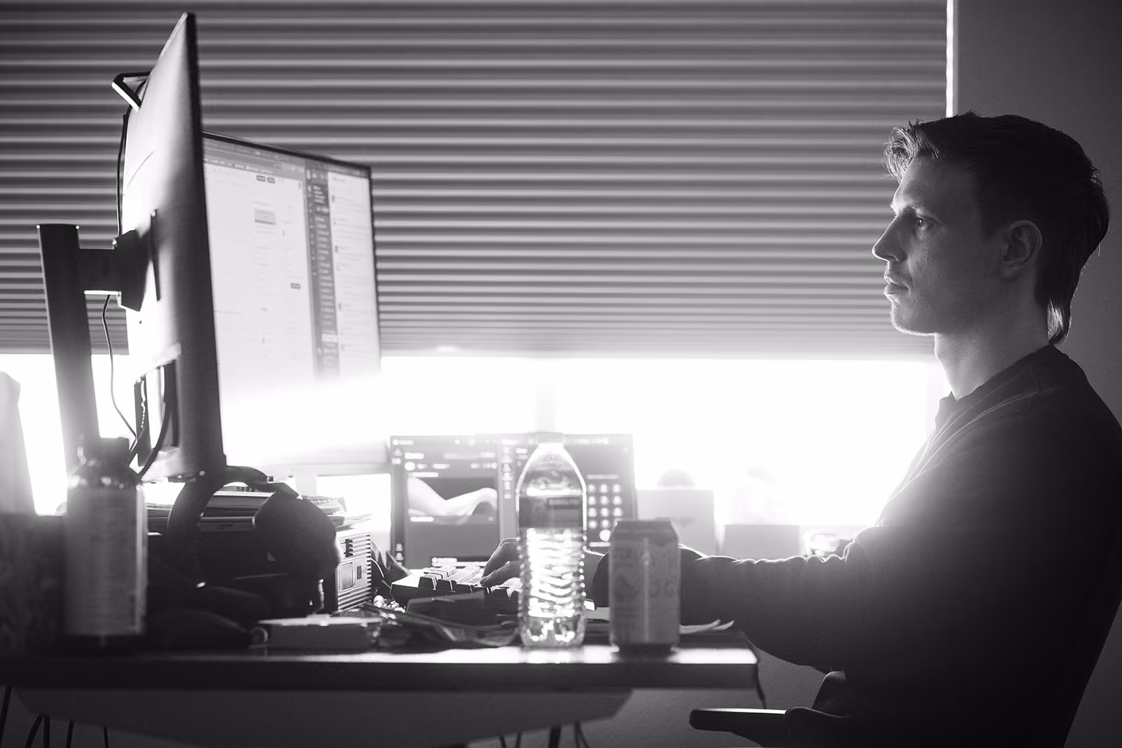 Stratus Employee sits at a desk and uses a computer to help clients.