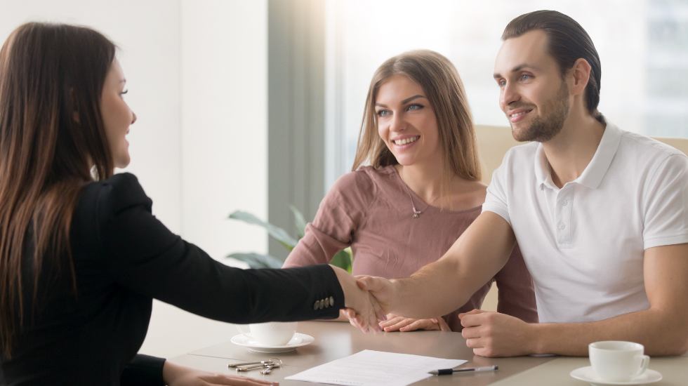 young couple meeting with a property manager