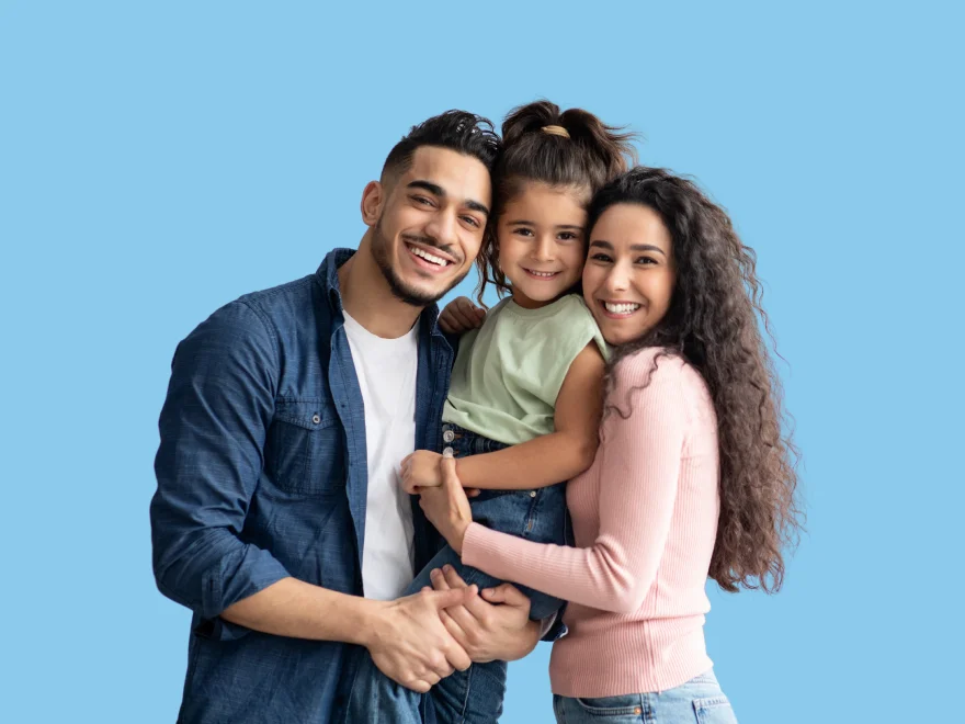 A man, woman and child posing for a picture.