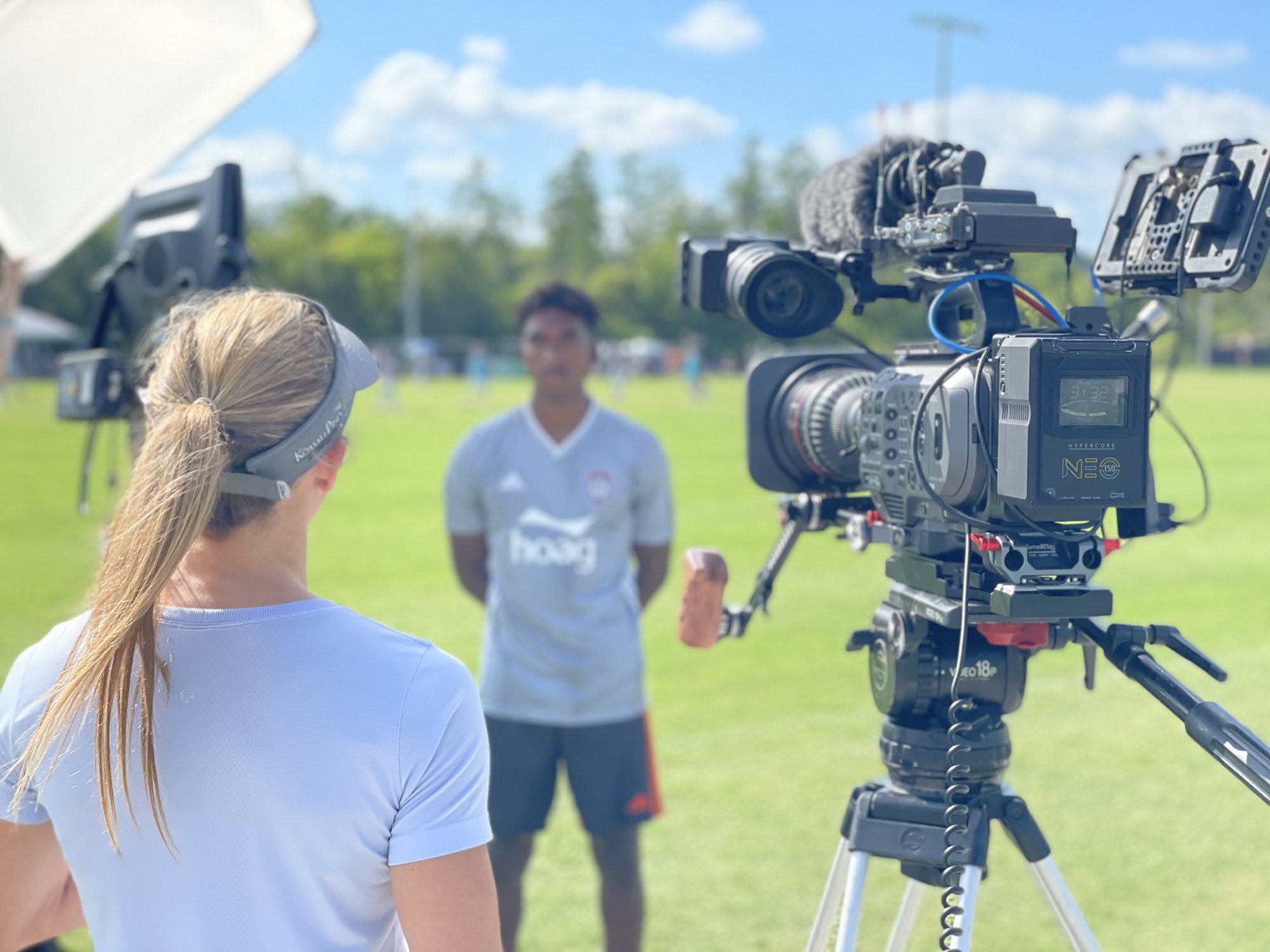 Greyline Media crew filming a post-training soccer interview on the pitch