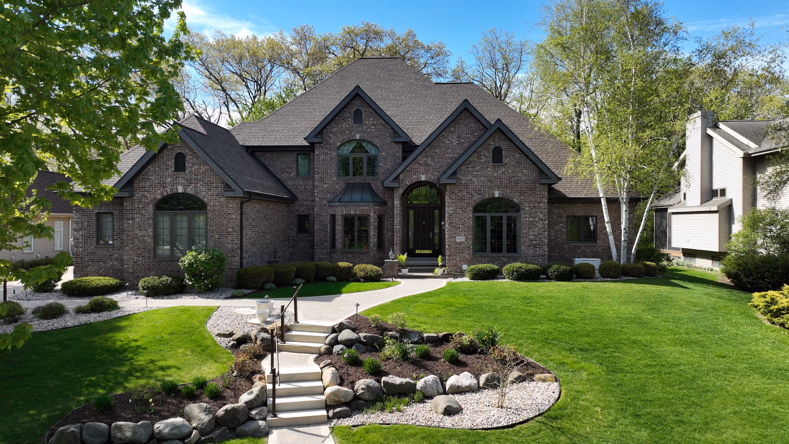 Brick two-story home in Madison, WI with an architectural asphalt shingle roof