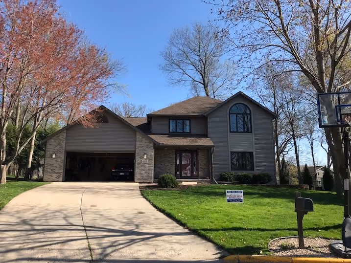 Front view of a two-story Wisconsin Rapids home with a dark asphalt shingle roof