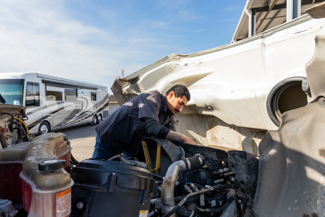 Diesel mechanic performing preventive maintenance services on semi truck in San Antonio, Texas