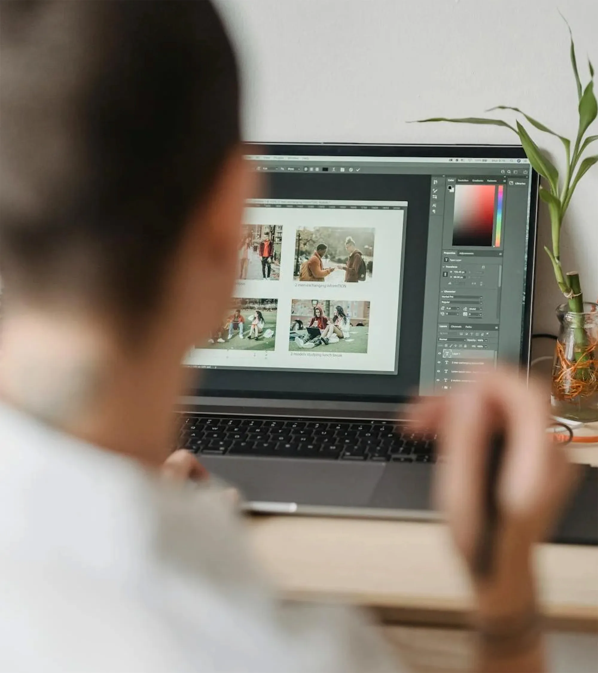 Laptop screen showing visual design work and image layout editing.