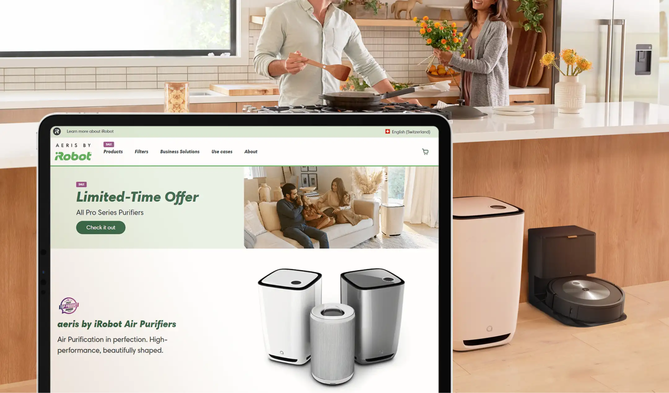 aeris by iRobot air purifiers in a modern kitchen while a couple cooks, representing a healthy home environment.