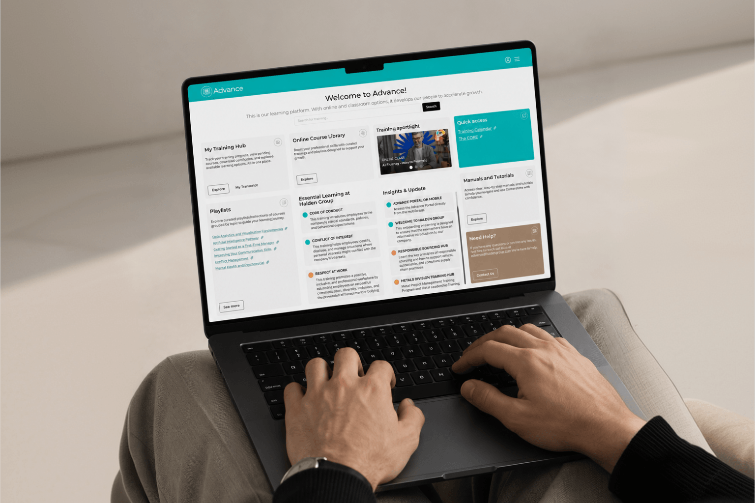 Learning platform Welcome Page redesign displayed on a laptop, showing the new modular grid layout with training hubs, essential learning, and quick access panels.