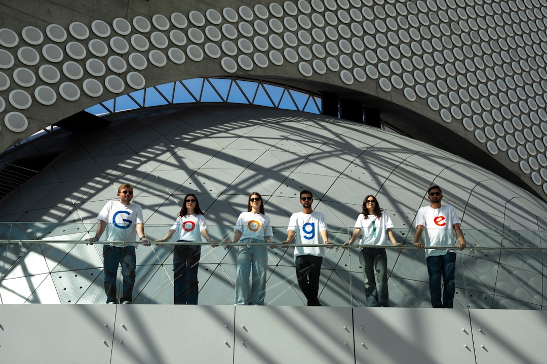 People wearing shirts with google logo and numbers collaborating