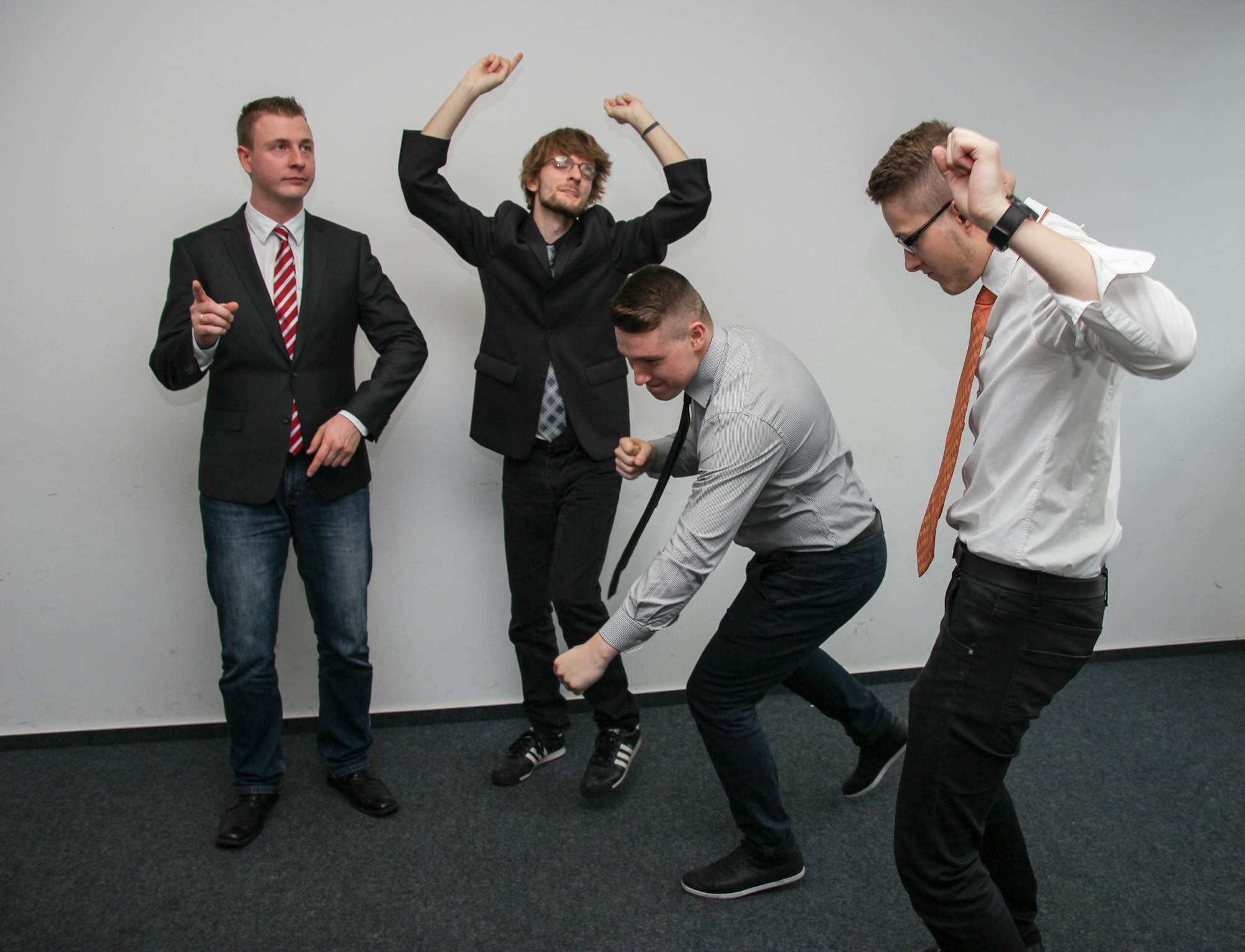 A group of people doing body gestures during a team building activity. Photo by Sebastian Herrmann on Unsplash